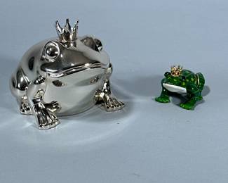 (2pc) DECORATIVE FROGS | Chromed prince frog coin bank and ceramic prince frog. - h. 4 x w. 3.5 x l. 5 in
