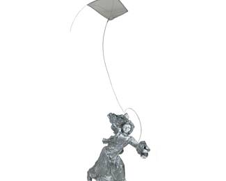SILVER PAINTED SCULPTURE | A large and unique sculpture designed as a young girl flying a kite, having realistic details with overall silver paint. - h. 96 x w. 45 x l. 60 in (approx)