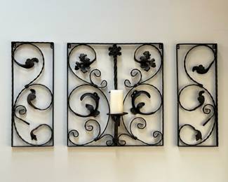 (3pc) WROUGHT IRON WALL APPLIQUÉS | Three panel garniture comprising two outer panels each 10” wide centering a panel with candle holder, with scrollwork decoration. - h. 25 x w. 24 x d. 7 in