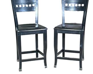 (2pc) PAIR BERMEX WOOD STOOLS | Made in Canada, a pair of black painted carved wood stools with curved back, seat height 24 in. - h. 40.5 x w. 17 x d. 18 in
