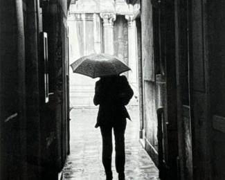European Umbrella Photograph | Framed black and white photograph of a figure on a rainy promenade. - h. 21.5 x w. 18 in (frame)