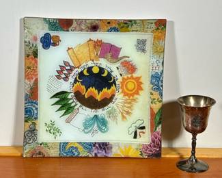 (2pc) MIXED JUDAICA ITEMS | Including: silver plate kiddush cup engraved with flowers & Star of David, and a colorfully decorated Hebrew platter. - w. 11.75 x l. 11.75 in