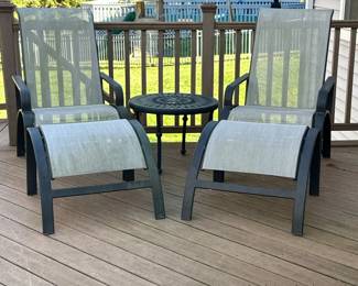 (5pc) WINSTON "SLING" EVOLUTION OUTDOOR ARM CHAIRS & TABLE | Including: pair of Winston Evolution Collection reclining armchairs with ottoman, and a round metal side table with decorative openwork top. - h. 41 x w. 25.5 x l. 57 in (chair with ottoman)
