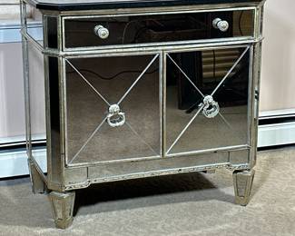 STONE TOP & MIRRORED CABINET | Side cabinet having a black stone top over full-width drawer and split door cabinet with 2 shelves, the exterior with paneled mirror sections. - h. 29 x w. 30 x d. 17 in