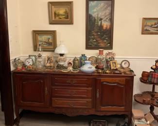 Sideboard, ginger jars, oriental large vase, glass lantern, clock, picture frames, camera, flip phones, brass vintage plate scene,  Italian dessert two tier side table.
Radio and cassette player. 
