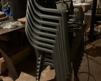 Stack of sturdy green thick plastic chairs, nails, screws and more. 