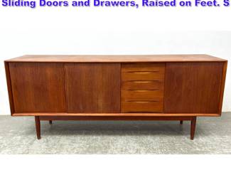 Lot 720 Danish Modern Teak Credenza. Sliding Doors and Drawers, Raised on Feet. S