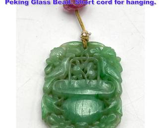 Lot 1137 Asian Carved Green Stone Pendant. Peking Glass Bead. Short cord for hanging. 
