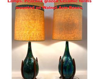 Lot 2082 Pr Glazed Lava Pottery MCM Table Lamps. Peacock glazed Ceramic forms mounted on Walnut Arm Bases.