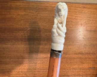 Carved lion fighting snake antique cane
