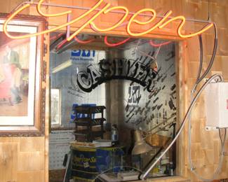 neon open sign and cashier glass window