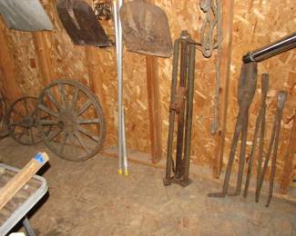 bumper jack, blacksmith tongs, old wheels, shovels