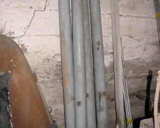 old porch columns and pipe on ground is for a tent