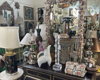Leather-clad bombe commode, Seashell-encrusted mirror, Puzzle side table with round marble top, and more.
