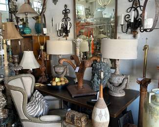 Painted winged bergere chair, Pair carved urn form lamps, Oval side table with Breche d'alp marble top, Grosfeld House plume table base, Scrolling iron sconces, and more