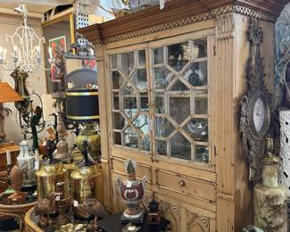 Neoclassical pine cabinet, Pair of oval reed-wrapped end tables, Pair hammered brass & copper tea can lamps, Handcarved wall clock, White-painted iron pagoda chandelier.