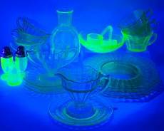 23pc Vintage Green Uranium Glass Lot Including Plates, Saucers, Tea Cups, Vase, Bowls, Salt Pepper Shakers, and Ladle Spoons
