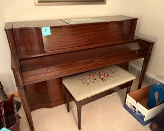 . . . a very nice upright piano with needlepoint bench