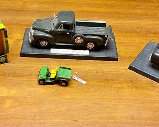 Lot 127-MC: Three Die-Cast Vehicles and a Baby