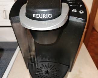 Keurig Coffee Maker plus lots of Coffee plugs. 