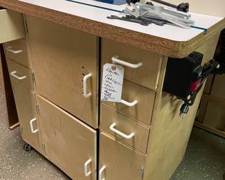 Router in custom made cabinet. Includes hose, wheels, adjuster fence, table and on/off switch