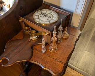 Wall Clock, Perfume Jars and Wooden Table.