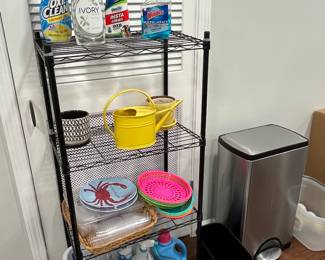 Metal shelving units, Simple Human trash can and cleaning supplies