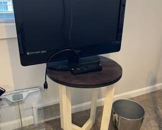 Vizio flatscreen TV and round occasional table