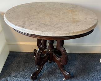 Victorian-era oval lamp table with marble top.