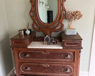 Victorian three-drawer dresser with swivel and pivot oval mirror.