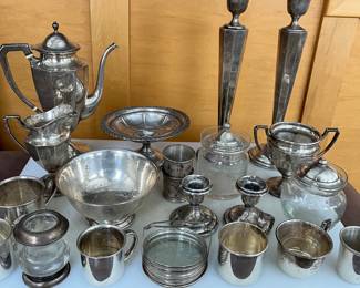 Assorted sterling silver bowls, cups, candlesticks, pitchers, and more.