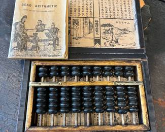 Antique abacus with box and paperwork.