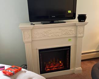 Electric fireplace gives off heat, TV