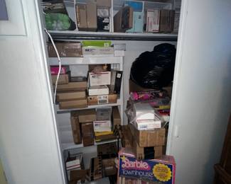 closet full of barbies and rare dolls in boxes