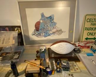 An array of sports memorabilia including an autographed football by  Mike Ditka