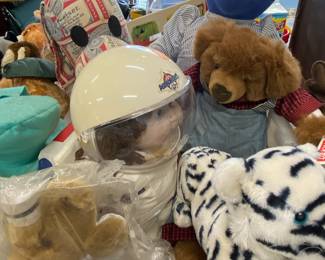Stuffed animals to include a cabbage patch doll(an astronaut), Budweiser dog is missing an ear!