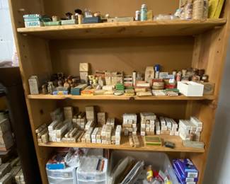 Top half of shelves is vintage medical boxes, Humphries medication boxes and the bottom half is for coin collecting ; different containers and more 