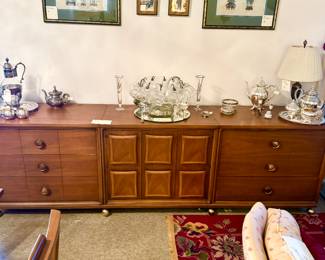 Broyhill Mid Century Modern buffet, silver punch bowl , silver serving pieces. 