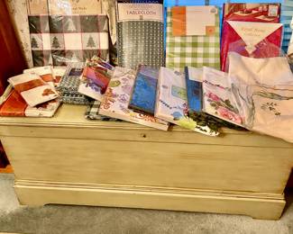 Vintage green painted cedar chest / trunk, table linens, most brand new in packages