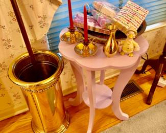 Brass umbrella stand, scalloped side table, linens