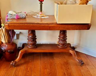 Beautiful antique oak Library Table with carved paw feet and 2 ornately carved columns and 2 draws.