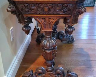 Side view of the Table showing the ornate dolphin Serpent feet. 