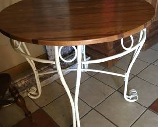 Outdoor table with pine tope. Wrought metal base.