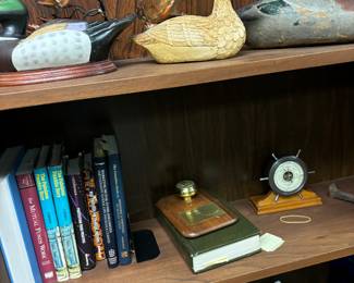 Bookshelf with books and ducks