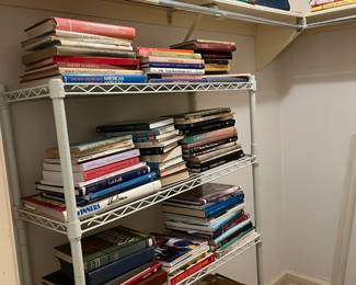 Walk in closet full of resource books for glass, pottery and various antique collections