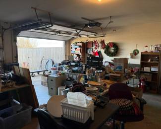 Garage full of games, electronics, file cabinets, books, and Christmas items.