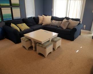 Coastal chic navy blue couch; coffee table with 4 upholstered stools