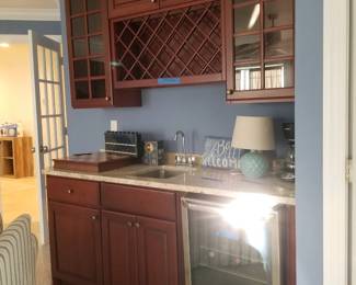 Handsome wet bar with Frigidaire under cabinet beverage fridge