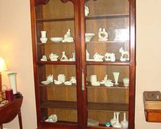 More Rookwood pottery in an antique walnut lawyers bookcase with two lower drawers