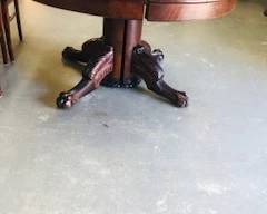 Mahogany antique table with 6 leaves One of the toes is missing from the table 